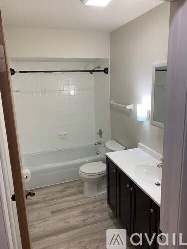 A bathroom with a toilet, sink, and bathtub.