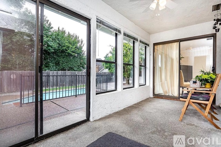 A room with a pool visible through the glass doors.