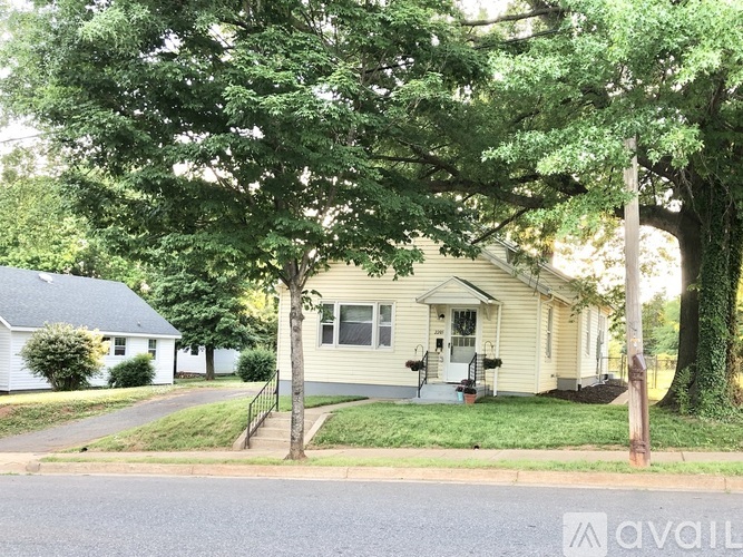 A house with a tree in front of it.