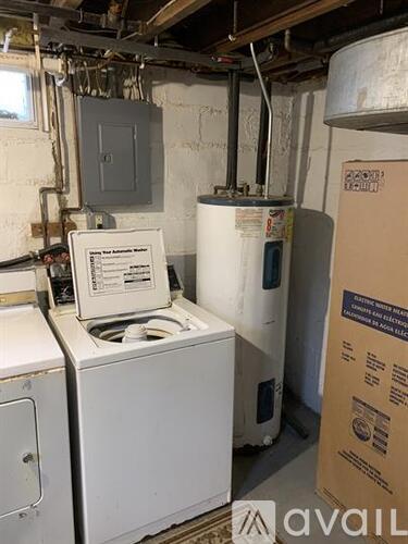 A white washing machine and dryer in a basement.