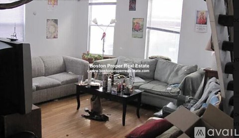 A living room with a grey couch and a coffee table.