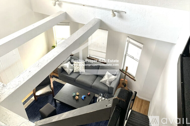 A living room with a grey couch and a coffee table.