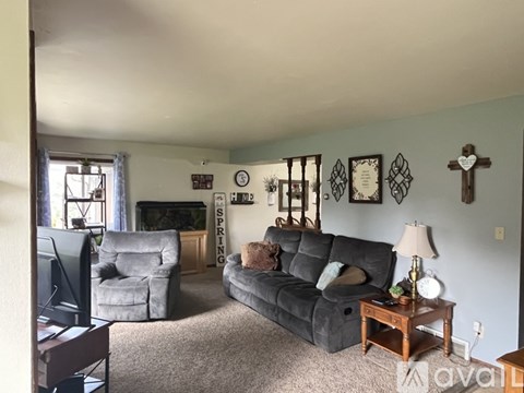A living room with a grey couch and a wooden coffee table.