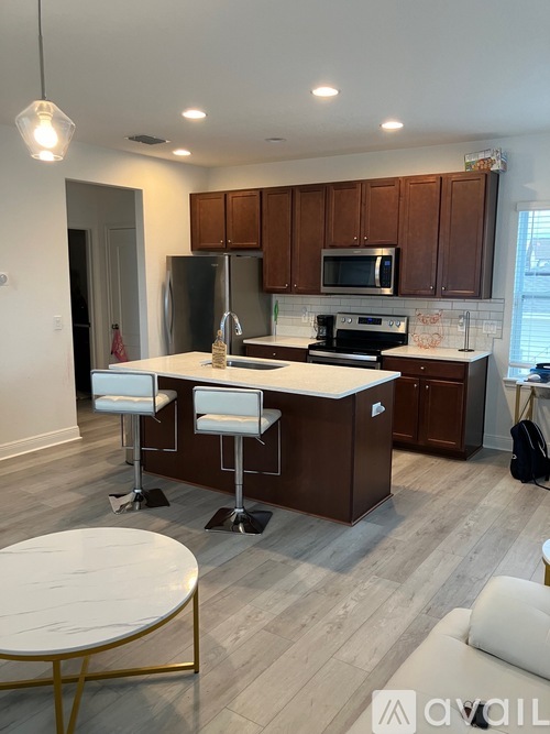 A kitchen with brown cabinets and a white island.