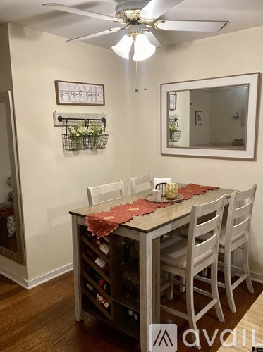 A dining room with a table set for four.