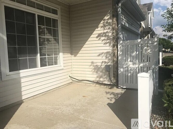 A house with a white fence and a window.