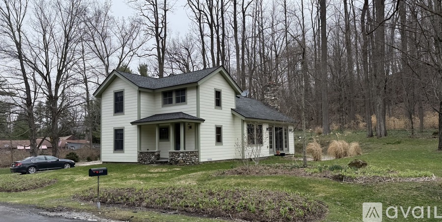 A house with a car parked in front of it.