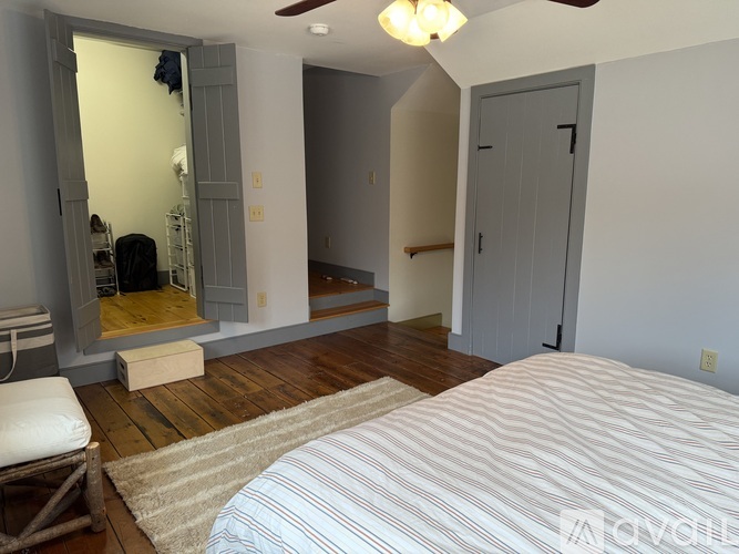 A bedroom with a bed, dresser, and mirror.