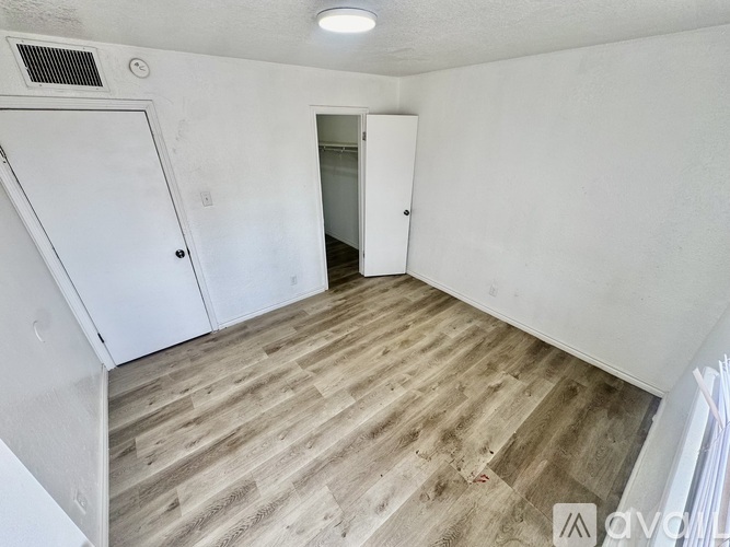 A room with a white door and a white cabinet.