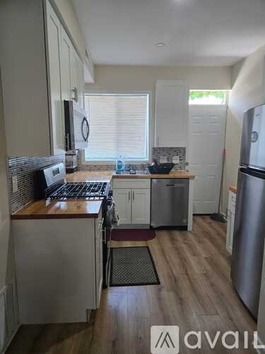 A kitchen with a stove top oven and a refrigerator.