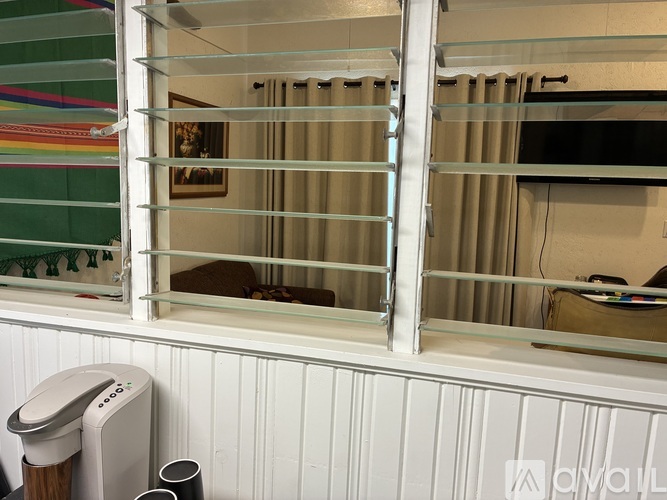 A window with a white frame and a glass pane is open.