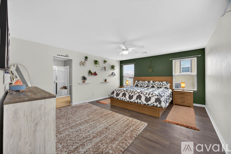 A bedroom with a bed, nightstands, and a rug.