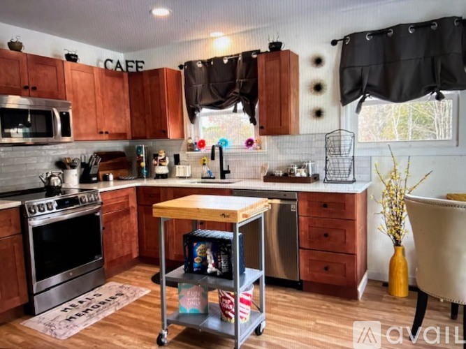 A kitchen with wooden cabinets and a stainless steel oven.