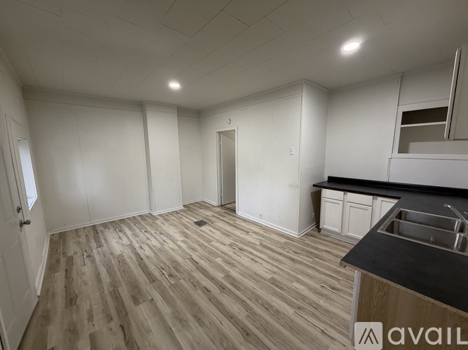 A kitchen with a sink and cabinets is available for rent.
