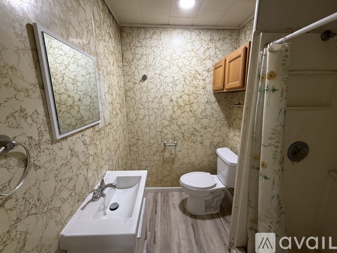 A bathroom with a sink, toilet, and shower.