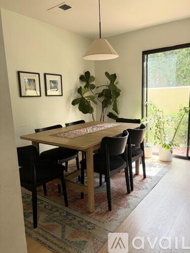 A dining room with a table and chairs.
