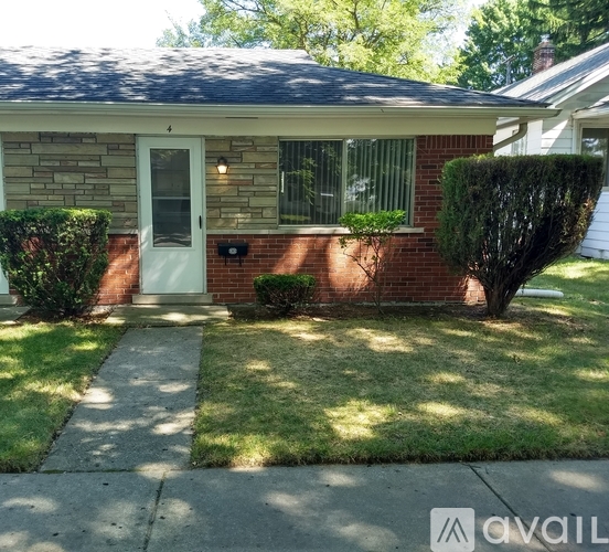 A house with a white door and a small front yard.