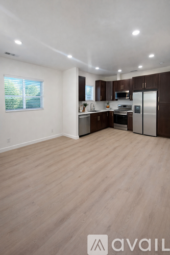 A kitchen with wooden floors and stainless steel appliances.