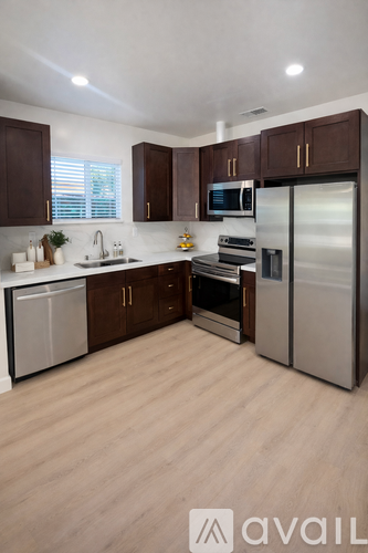 A kitchen with wooden cabinets and stainless steel appliances.