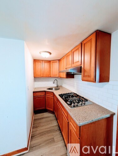 A kitchen with wooden cabinets and a granite countertop.