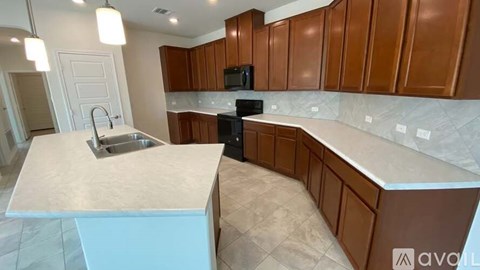 A kitchen with brown cabinets and a white countertop.