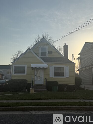 A house with a yellow front and a white door.