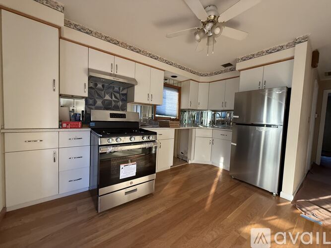 A kitchen with a stove top oven and a refrigerator.
