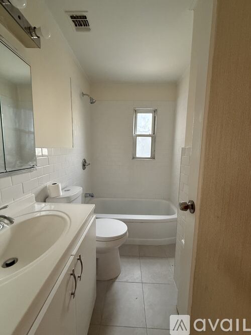 A bathroom with a toilet, sink, and bathtub.