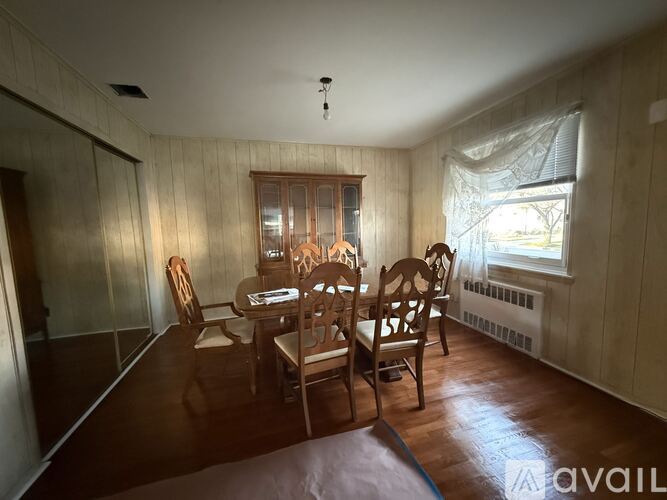 A dining room with a table set for four.