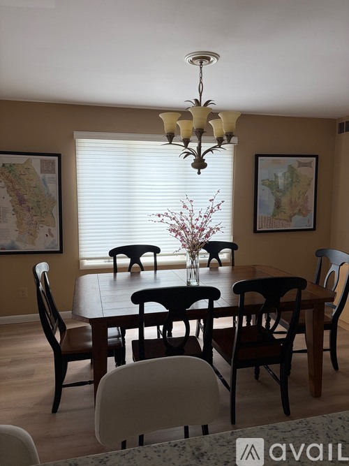 A dining room with a table set for six.