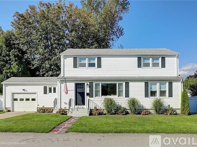 A two-story house with a garage on the left side.