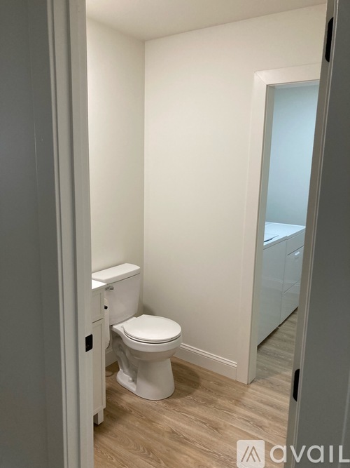 A white toilet in a small bathroom.