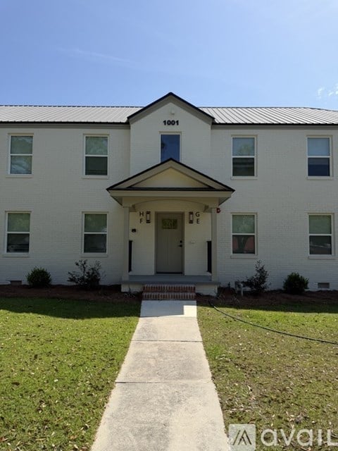 A white building with a black roof and a sign that says "1001" on it.