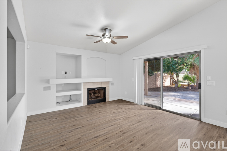 A spacious living room with a fireplace and sliding glass doors.
