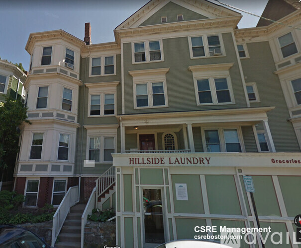 A multi-story building with a sign that says "Hillside Laundry".