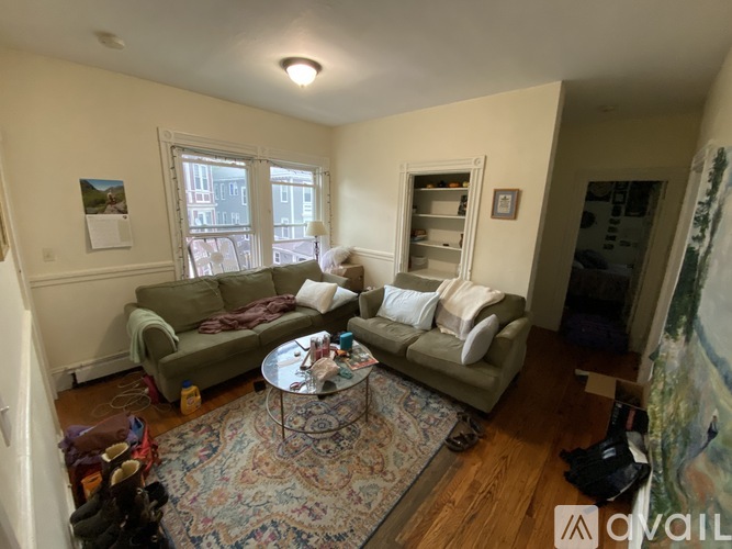 A living room with a rug, two couches, and a coffee table.