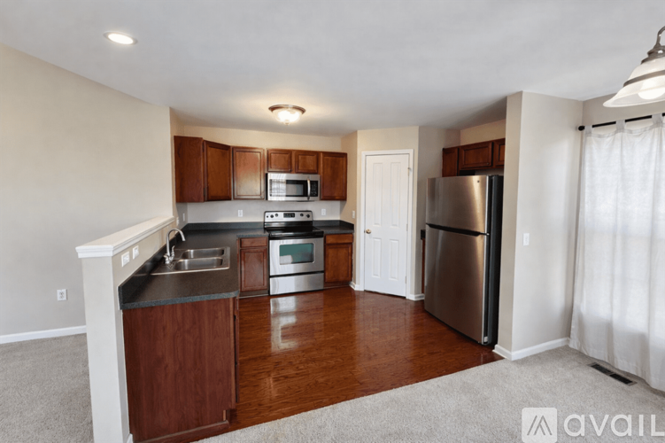 A kitchen with wooden cabinets and stainless steel appliances.
