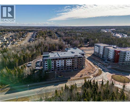 A realtor logo is visible on an aerial image of a residential area.