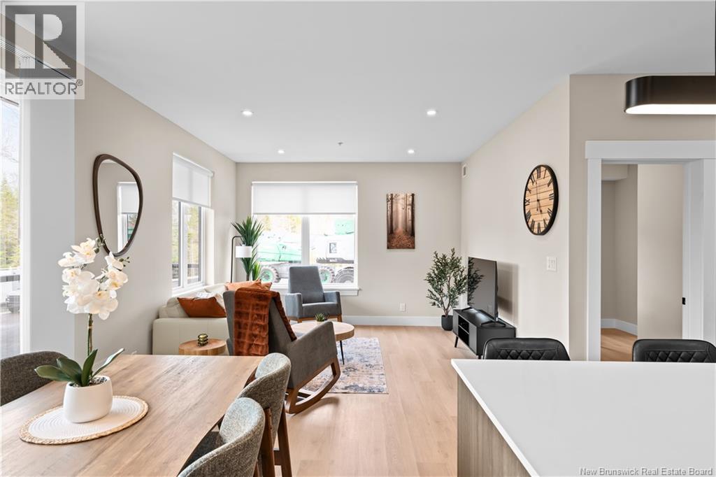 A living room with a wooden table and chairs.