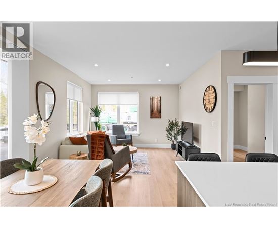 A living room with a wooden table and chairs.