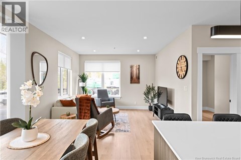 A living room with a wooden table and chairs.