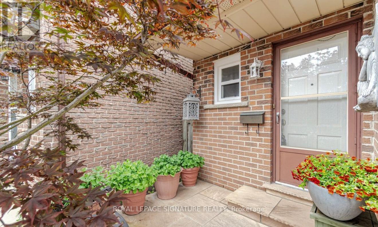 A small front yard with a red door and a mailbox.