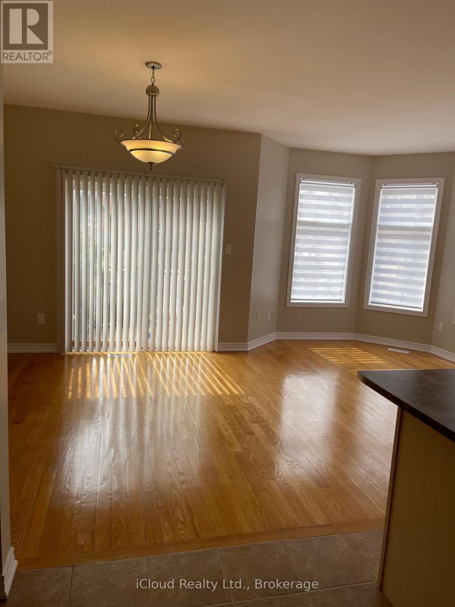 A room with wooden floors and a chandelier.