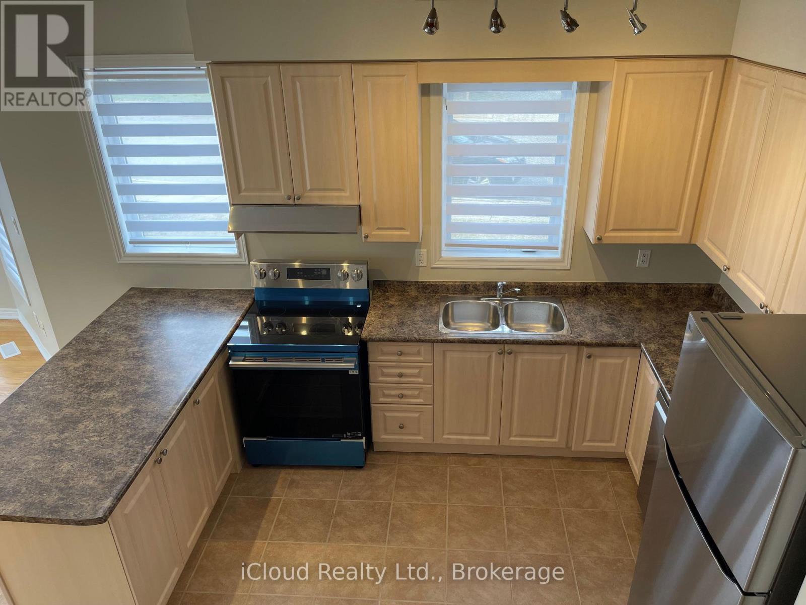 A kitchen with wooden cabinets and granite countertops.