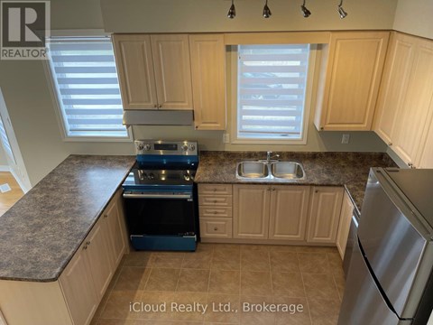 A kitchen with wooden cabinets and granite countertops.