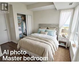 A bedroom with a large bed and a window with curtains.
