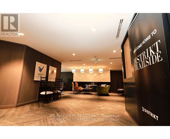 A modern office space with a black and white color scheme and a sign that reads "District Trailside.".