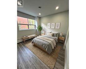 A bedroom with a large bed and a window.