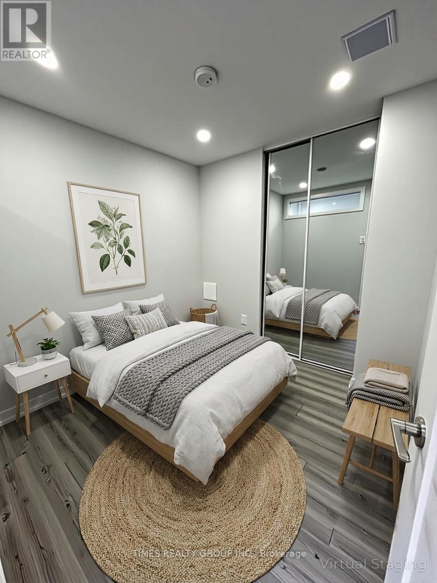 A bedroom with a bed, nightstand, and a rug.