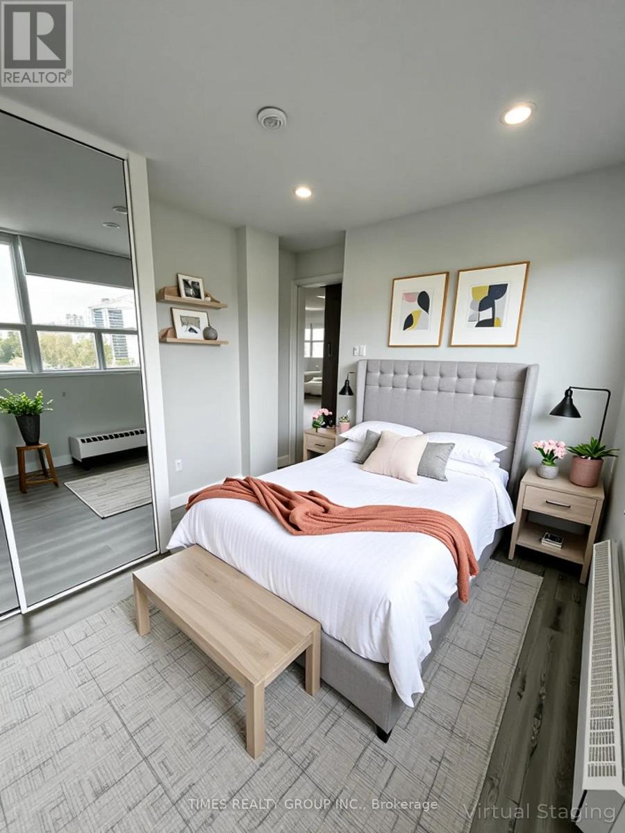 A bedroom with a bed, nightstand, and a window.